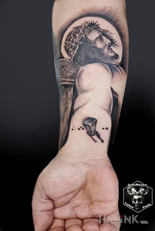 Tattoo Jezus in black and gray motif and realistic style On the arm