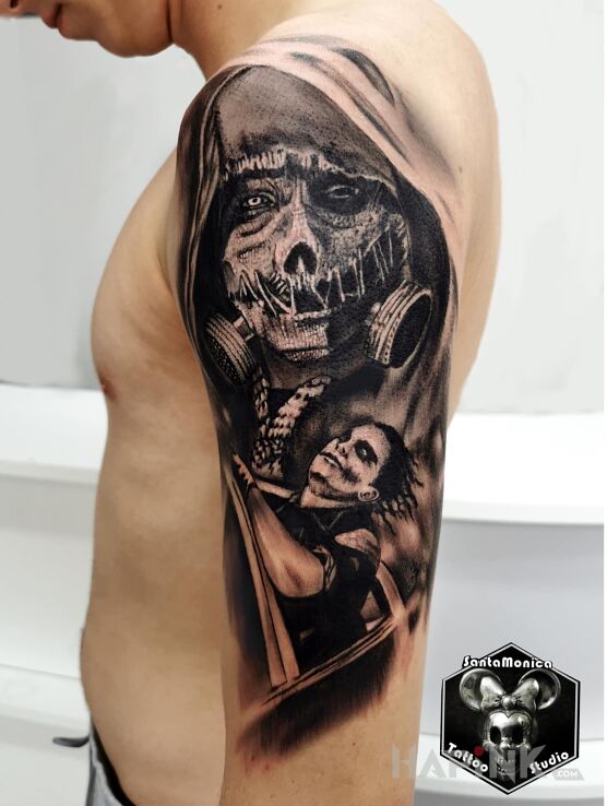 Tattoo Joker in faces motif and realistic style on the upper arm