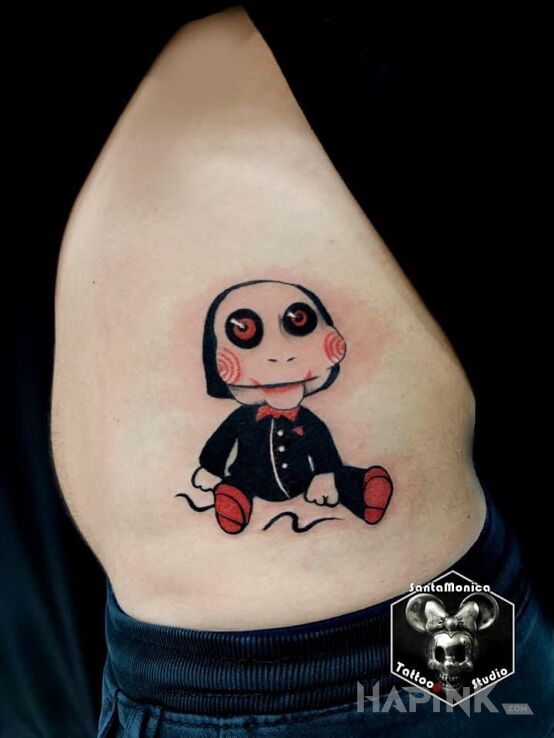 Tattoo Piła horror in colorful motif and cartoon / comic book style on the ribs