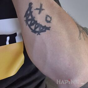 Tattoo Smile tattoo on the forearm motif: black and gray style: graphic / illustrative