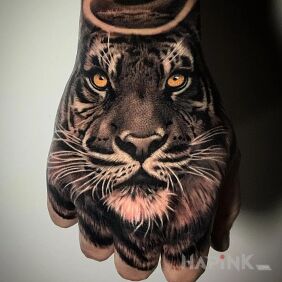 Tattoo Saint tiger on the hand motif: black and gray style: realistic