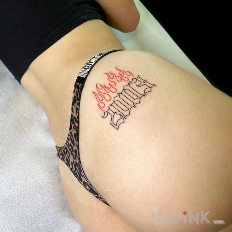 Tattoo 2003 in other motif and minimalistic style on the buttocks
