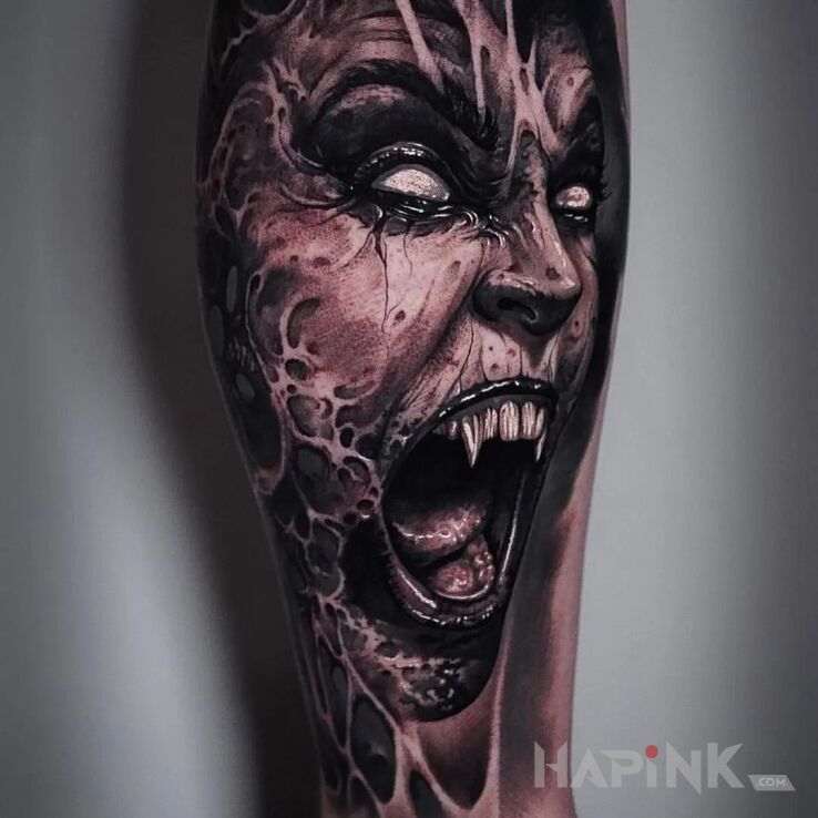 Tattoo Krwiożercza bestia in dark motif and realistic style on the leg