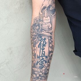 Tattoo Beginning of a Japanese-style sleeve patchwork On the arm motif: flowers style: graphic / illustrative