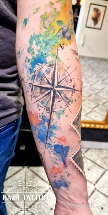 Tattoo Kompas in colorful motif and abstract style On the arm