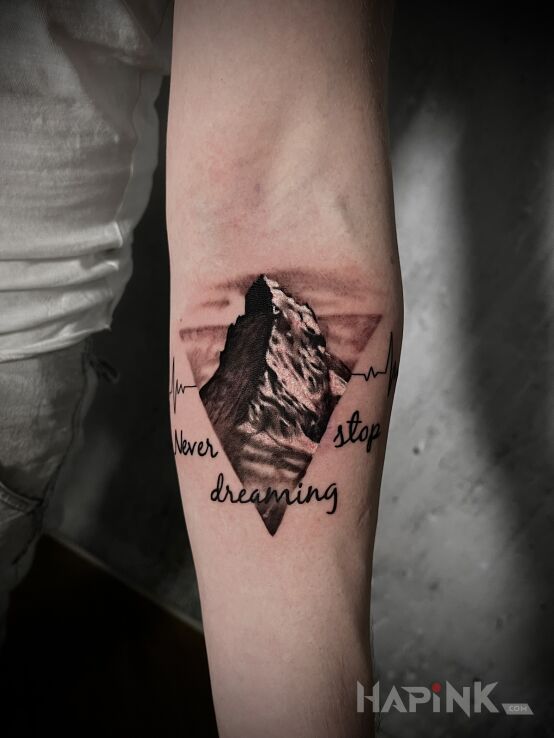 Tattoo Góry in nature motif and realistic style on the forearm