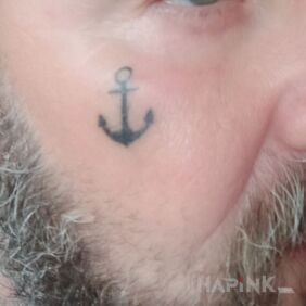 Tattoo Anchor on the face motif: black and gray style: minimalistic