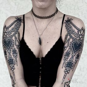 Tattoo Black sparkles on the shoulder motif: black and gray style: realistic
