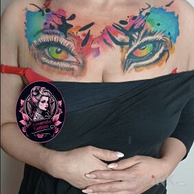 Tattoo Woman's eye and tiger's eye on the collarbone motif: colorful style: Watercolor