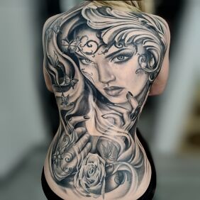 Tattoo Healed cover on the back motif: faces style: realistic