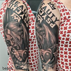 Tattoo Harley Quinn on the upper arm motif: lettering style: realistic