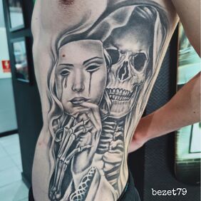 Tattoo Death with a mask on the ribs motif: skulls style: realistic