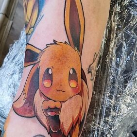 Tattoo Pokemon Eevee On the arm motif: characters style: cartoon / comic book
