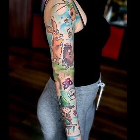 Tattoo Moomins on the upper arm motif: colorful style: cartoon / comic book
