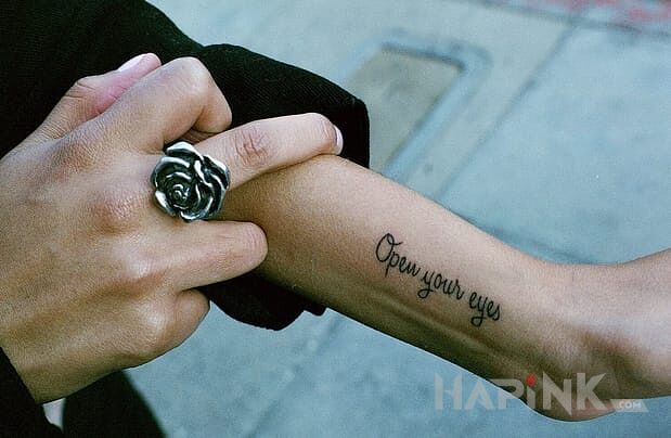 Tattoo Krótki napis in lettering motif on the forearm