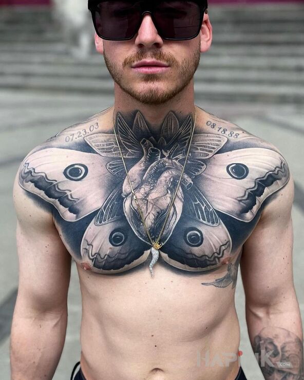 Tattoo Black heart in black and gray motif and realistic style on the collarbone