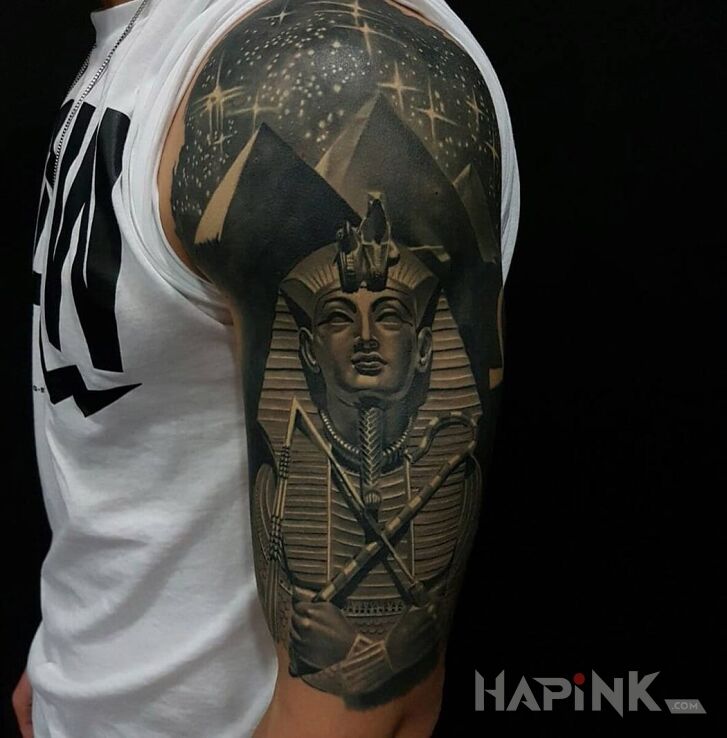 Tattoo Faraon in characters motif and realistic style on the upper arm