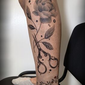 Tattoo Scissors and a Rose on the calf motif: black and gray style: graphic / illustrative