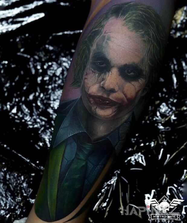 Tattoo Joker in characters motif and realistic style on the calf