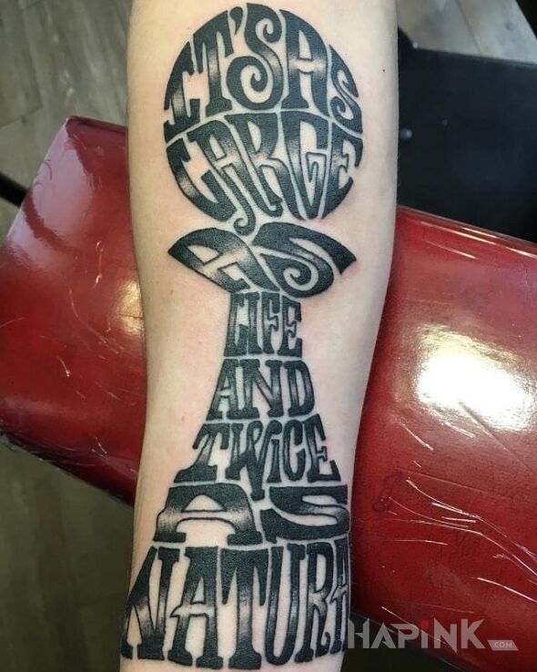 Tattoo Dziwny napis in lettering motif on the forearm