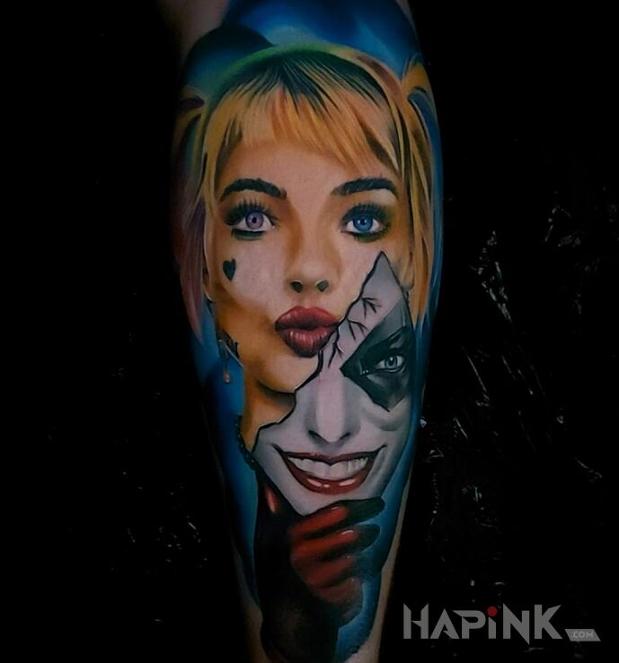 Tattoo Harley Quinn in characters motif and realistic style on the upper arm
