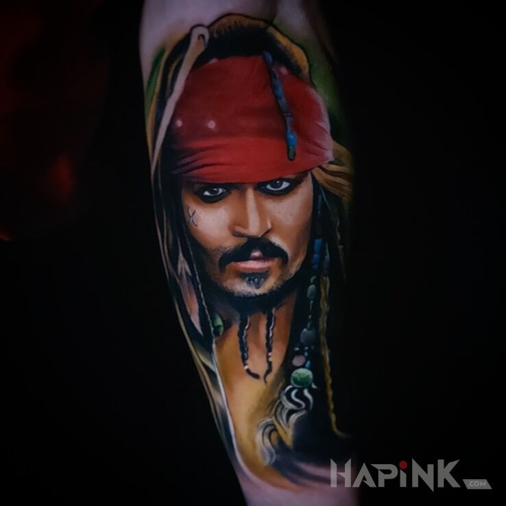 Tattoo Jack Sparrow in characters motif and realistic style On the arm