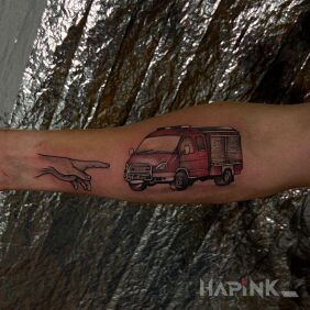 Tattoo Fire truck with a hand On the arm motif: colorful style: graphic / illustrative