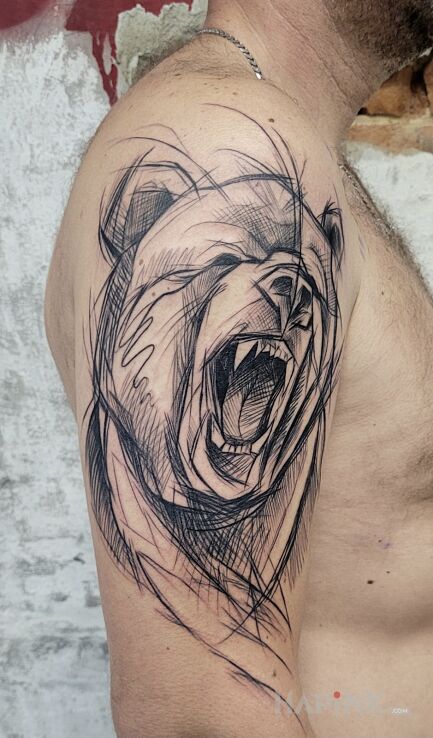 Tattoo Niedźwiadek in black and gray motif and sketch style On the arm