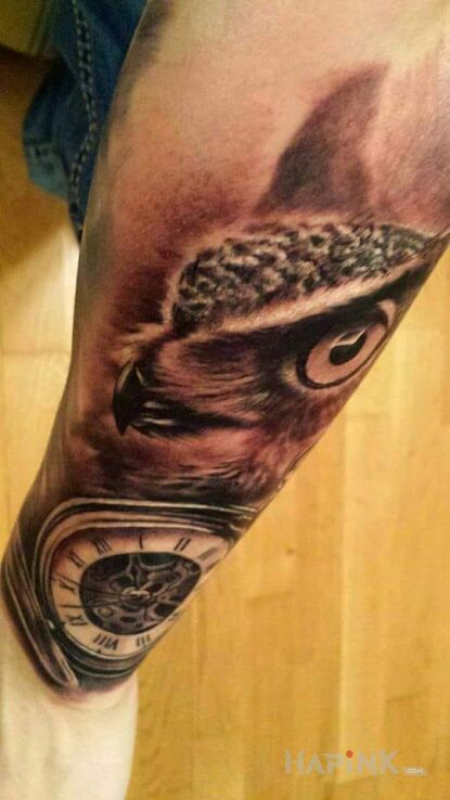 Tattoo Sowa i zegar in animals motif and realistic style on the forearm