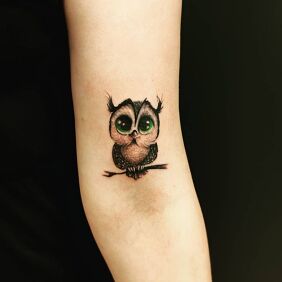 Tattoo Female owl tattoo On the arm motif: black and gray style: graphic / illustrative