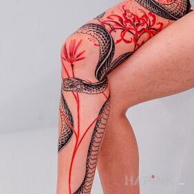Tattoo Red flowers with a snake intertwined on the tibia motif: flowers style: graphic / illustrative