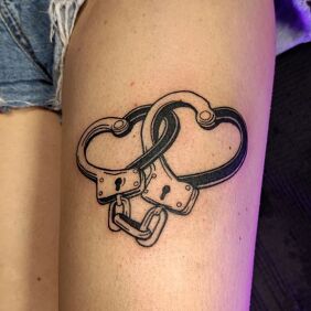 Tattoo Thigh tattoo of a heart with shackles on the thigh motif: objects style: contour / linework