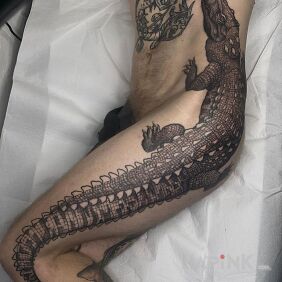 Tattoo Lacoste on the thigh motif: black and gray style: realistic