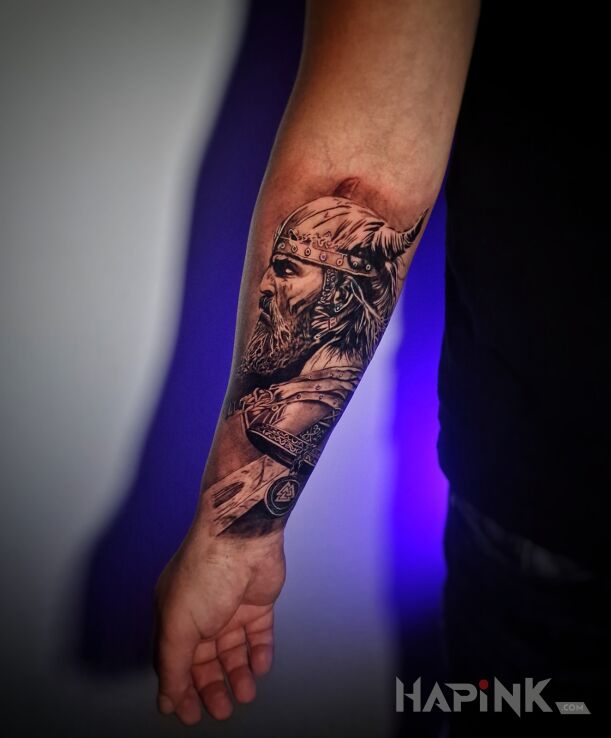 Tattoo Wiking na przedramieniu in faces motif and realistic style on the forearm