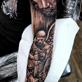 Tattoo Jesus on the bicep motif: faces style: realistic