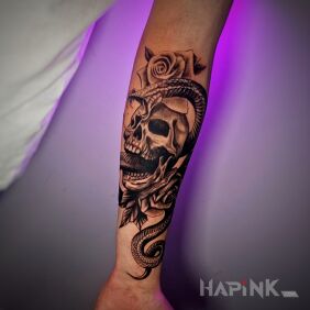 Tattoo Skull, rose and snake on the forearm On the arm motif: skulls style: realistic