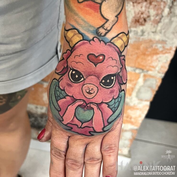 Tattoo Koza in colorful motif and newschool style on the hand