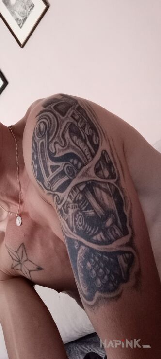 Tattoo Biomechanika in black and gray motif and biomechanics style on the upper arm