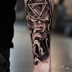 Tattoo Femida On the arm motif: faces style: realistic