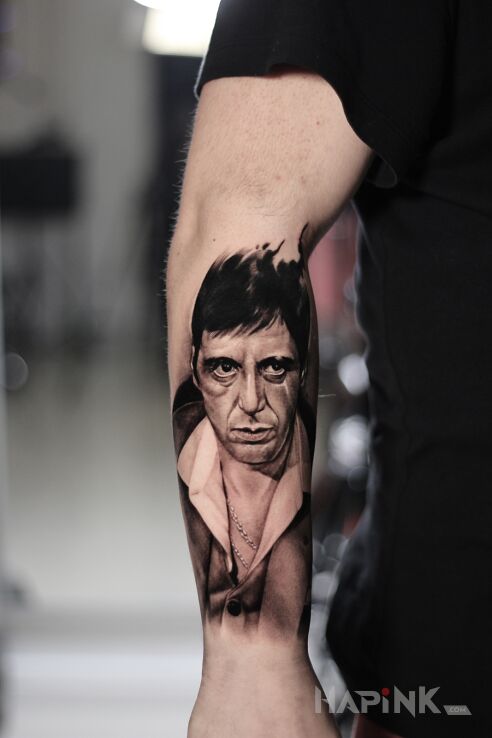 Tattoo Tony Montana in black and gray motif and realistic style On the arm