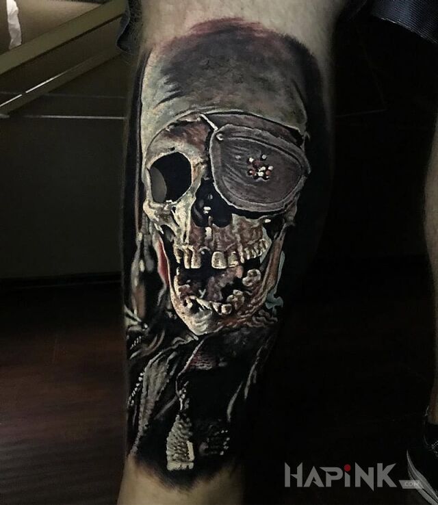 Tattoo Pirat in skulls motif and realistic style on the leg