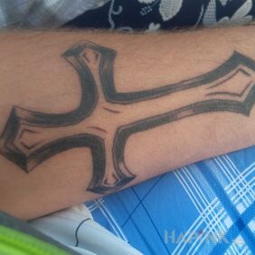 Tattoo Dziara on the forearm motif: religious