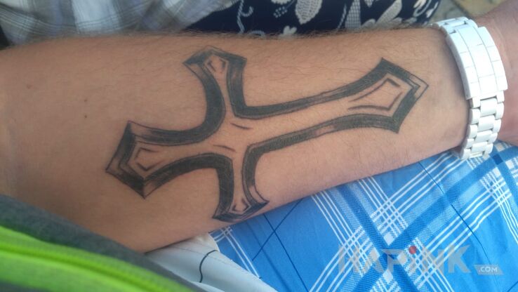 Tattoo Dziara in religious motif on the forearm