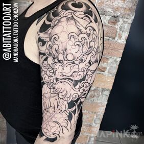 Tattoo Komainu on the upper arm motif: animals style: japanese / irezumi