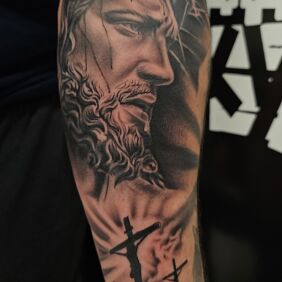 Tattoo Jesus on the forearm motif: black and gray style: realistic