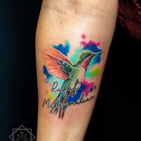 Tattoo Forearm tattoo colorful female hummingbird on the forearm motif: lettering style: realistic