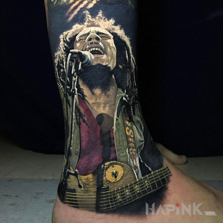 Tattoo Bob Marley in characters motif and realistic style on the leg