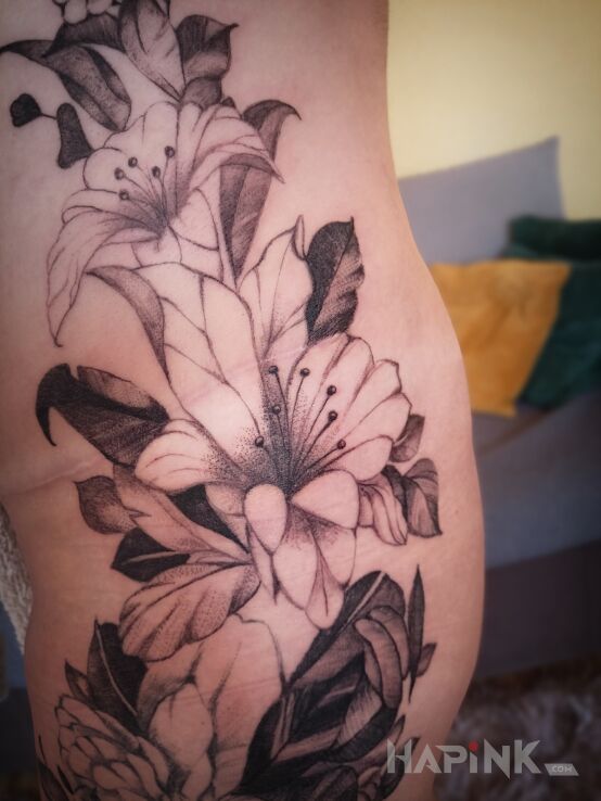 Tattoo Flowers in flowers motif and realistic style on the hip