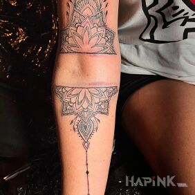 Tattoo Mandala on the forearm motif: black and gray style: contour / linework