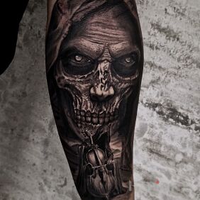 Tattoo Playing Death on the forearm motif: demons style: realistic